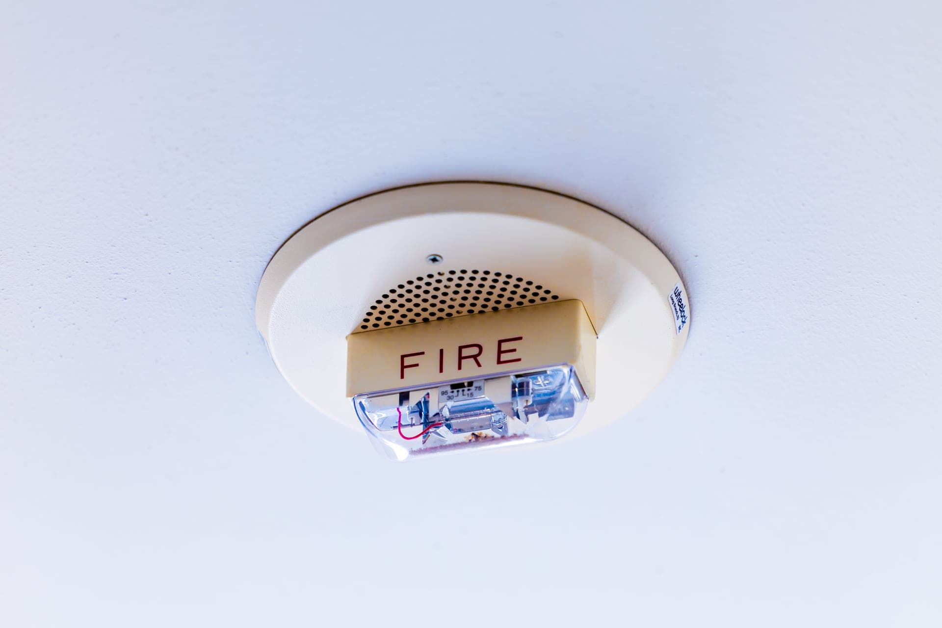 Ceiling-mounted smoke alarm in a quiet upstairs hallway