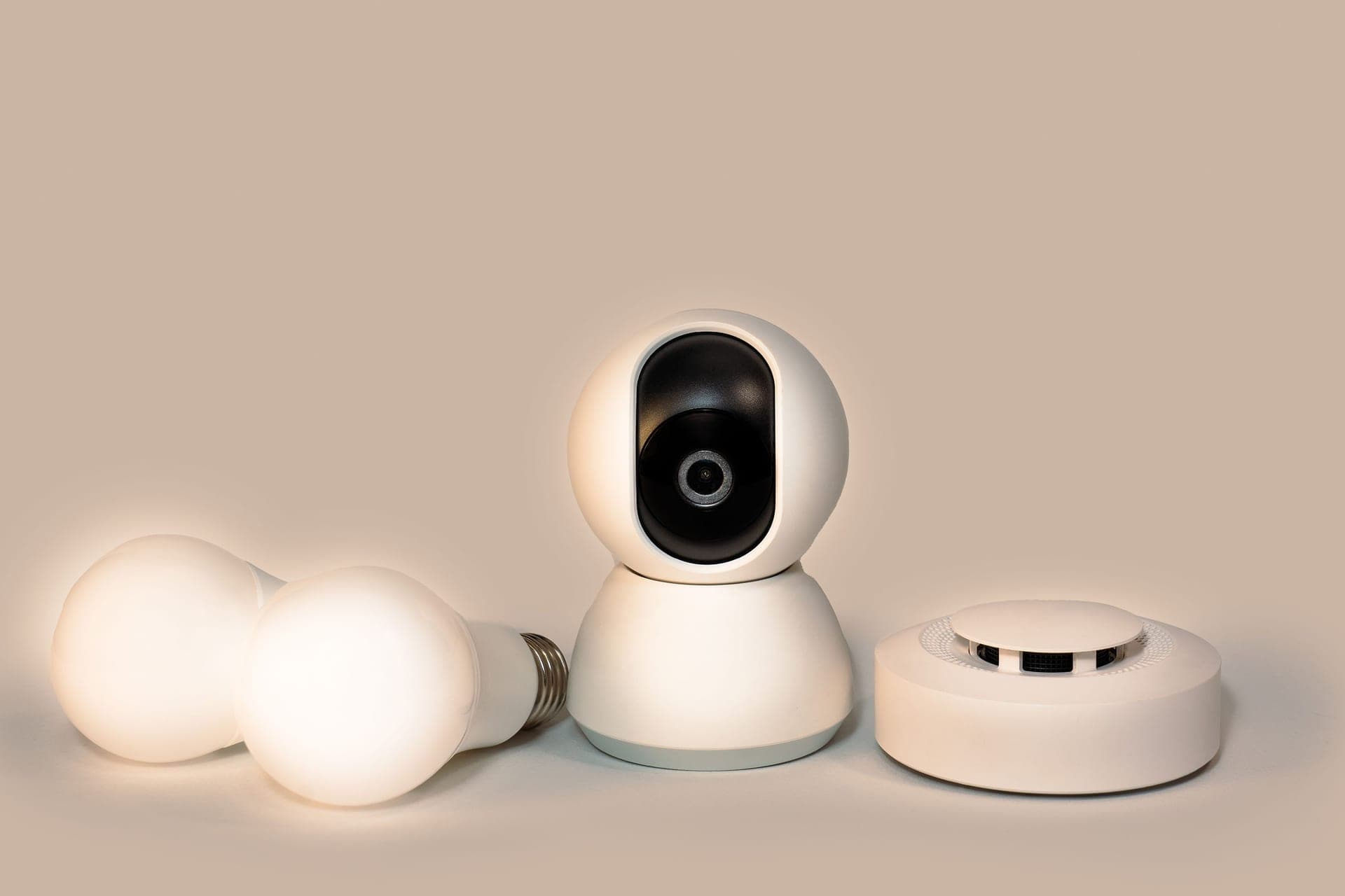 Illustrative photo of a battery-powered carbon monoxide alarm with a digital readout on a bedside table